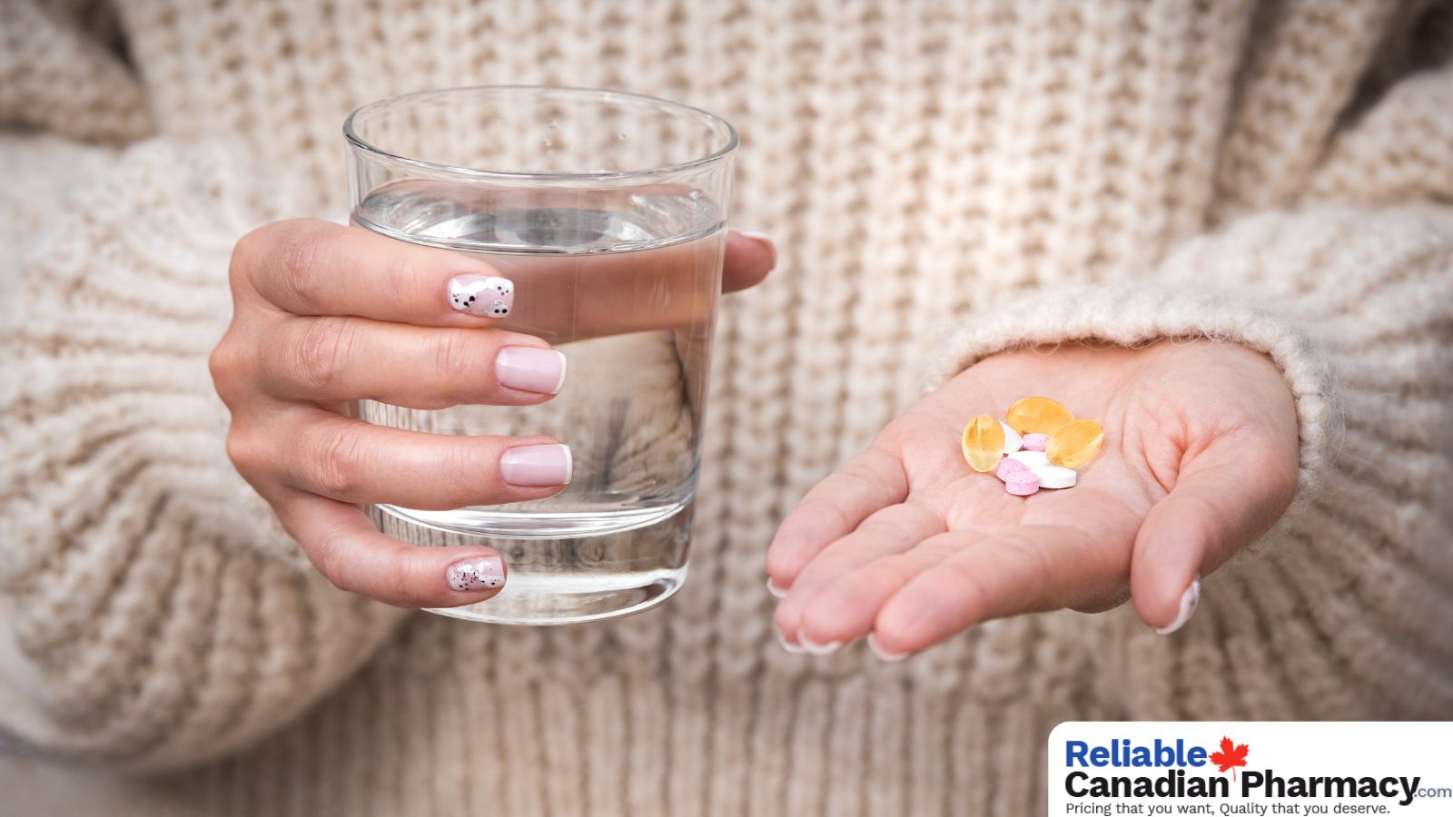 A person holding a glass of water and pills