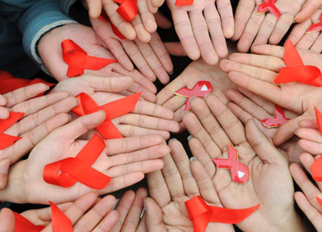 HIV ribbon in many hands