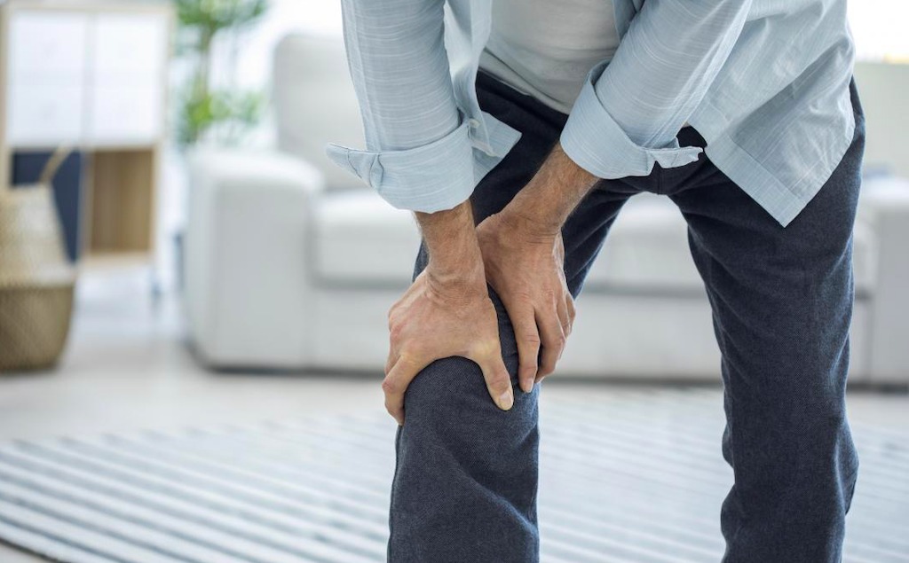 Man holding his leg due to pain