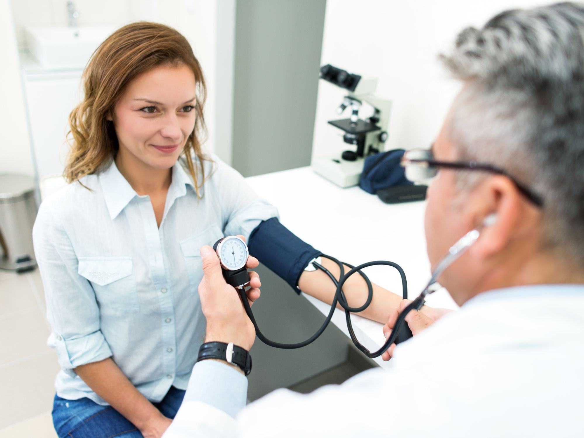 Doctor checking blood pressure of a patient