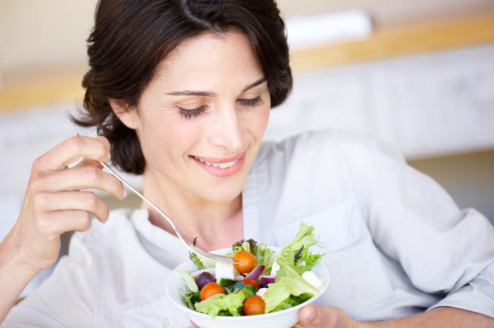 girl holding a bowl of veggies